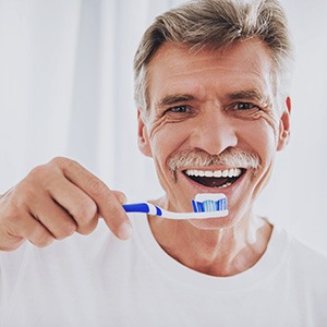 Man holding toothbrush and toothpaste