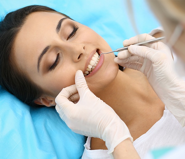 Woman receiving scaling and root planing treatment