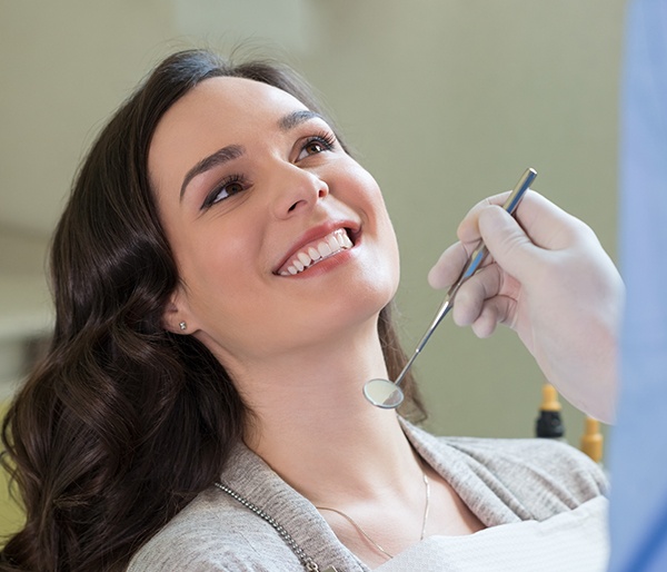 Woman smiling at dentist during dental checkup