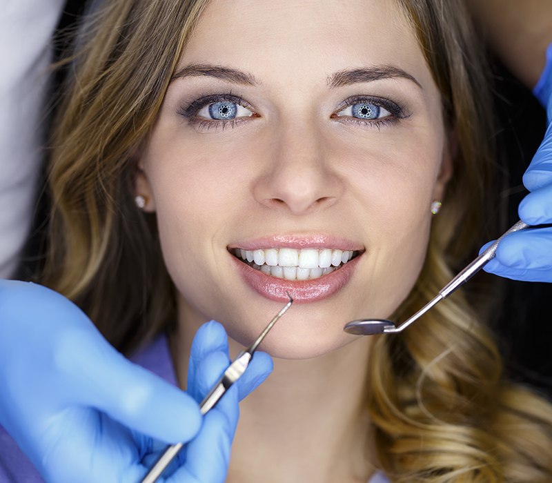 Woman receiving dental checkup treatment