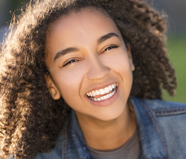 Young girl with healthy smile with fluoride treatment