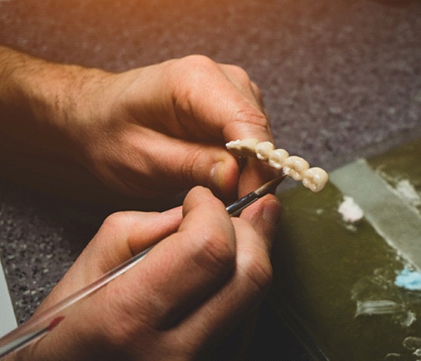 person making a dental bridge