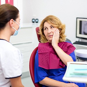 Patient and dental team member discussing cost of emergency care