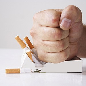 Man crushing cigarettes