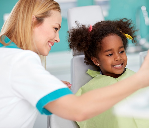 Child talking to dental team member during dental checkup