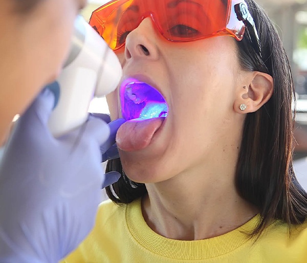 Dentist conducting oral cancer screening