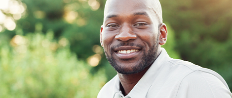 Man smiling after replacing missing teeth