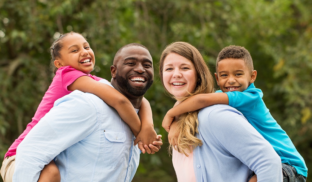 Family of four with healthy smiles thanks to dental services in Flint Michigan