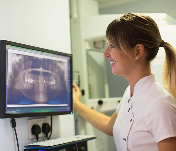 Dental team member looking at digital x-rays