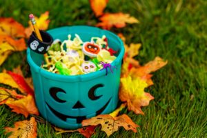 a teal jack-o-lantern bucket filled with non-food treats