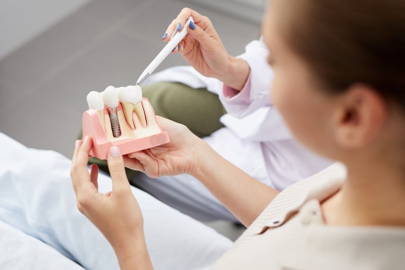 patient looking at a dental implant