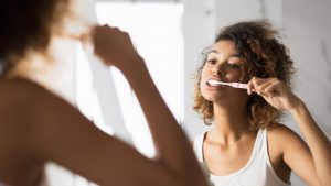 Person brushing teeth during COVID-19 pandemic