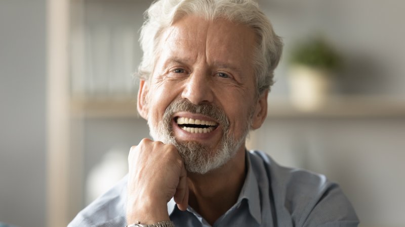 older man wearing dentures and smiling