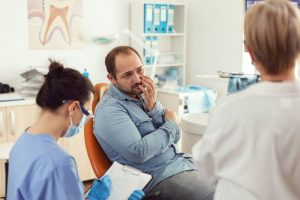 patient in pain speaking to dentist